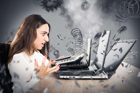Businesswoman with worried expression with computer exploded