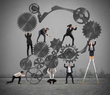 Teamwork of businesspeople work together to a system of gears