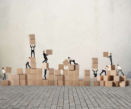 Business person built together a wood cubes constructionの写真素材