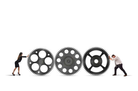 Teamwork of businesspeople work together to a system of gearsの写真素材