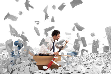 Concept of bureaucracy with man paddling in a sea of sheetsの写真素材