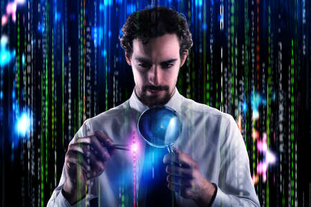 Businessman take with tweezers a binary number and looks it with the magnifying glass