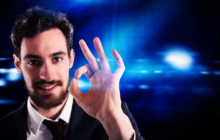 Confident and positive businessman makes gesture ok