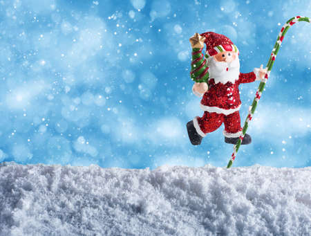 Cute puppet of Santa Claus wishes merry christmas on the snowの写真素材