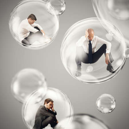 Sad businessmen flies in a bubbles. isolate themselves inside a bubbles detachment from the outside world conceptの写真素材