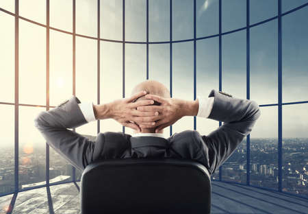 Businessman enjoys his professional success. Mixed mediaの写真素材