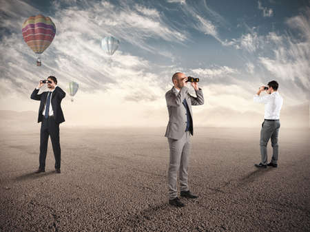 Business people looking for new job opportunities with binoculars