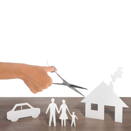 Woman cut out silhouettes of family car and houseの写真素材