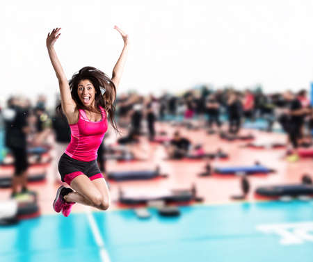Fitness teacher jumps at the gym