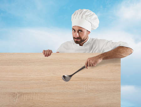 Chef with ladle and boardの写真素材