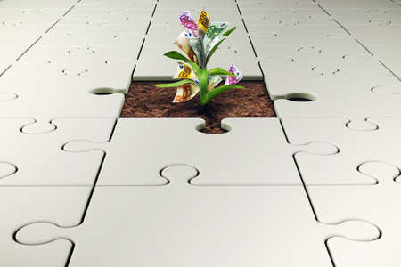 Plant with money grows from a missing piece of puzzleの写真素材