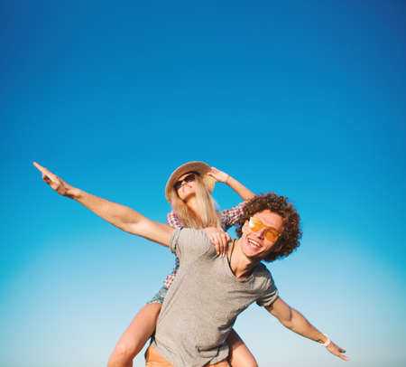 Happy smiling couples playing at the beachの写真素材
