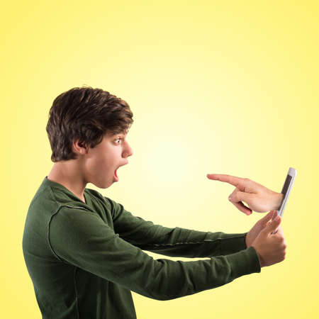 Hand indicating comes out of the tabletの写真素材