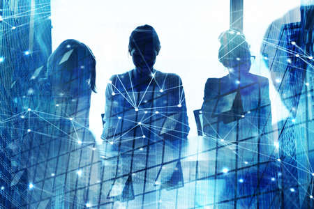Silhouette of businessperson in a modern office with network effect. concept of partnership and teamworkの写真素材