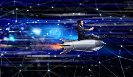 Fast internet concept with a businessman over a rocketの写真素材