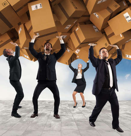 People buried by a stack of cardboard boxes. Concept of internet shopping addictionの写真素材