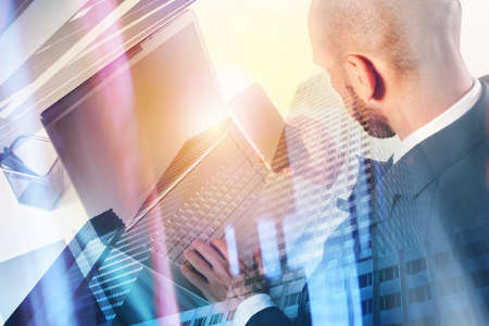 Businessperson in office connected on internet network with laptopの写真素材