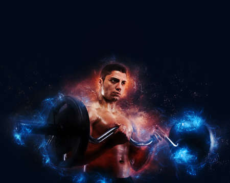 Athletic man training biceps with energy light effectの写真素材