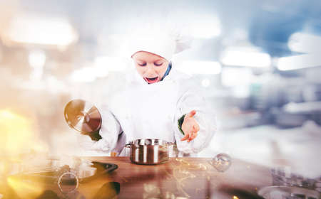 Young chef invents in the kitchenの写真素材