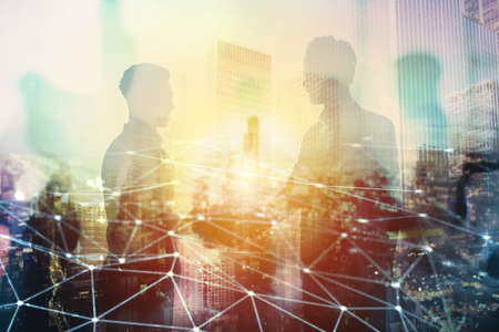 Handshake of two businessperson in office with network effect. concept of partnership and teamworkの写真素材