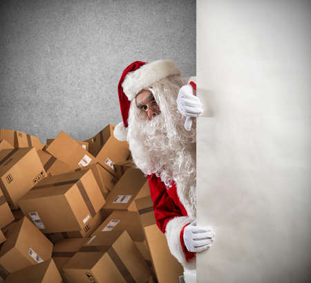 Santa Claus ready to deliver a lot of Christmas presents packageの写真素材