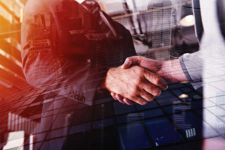 Handshaking business person in the office. concept of teamwork and business partnership. double...