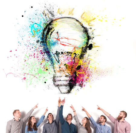 Brainstorming concept with businessmen that indicate an a lamp. Concept of idea and company startupの写真素材