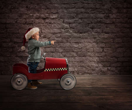 Child that play with his car waits for Santa Clausの写真素材