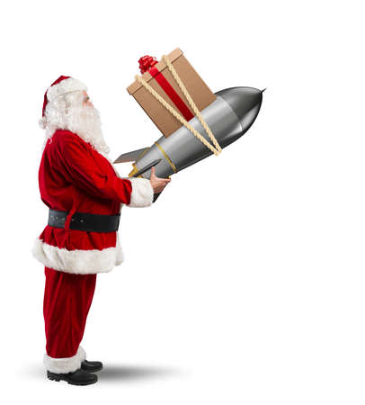 Fast delivery of Christmas gifts. Santa Claus ready to launch a rocketの写真素材