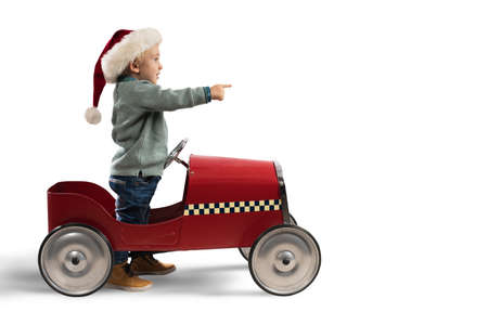Child that play with his car waits for Santa Claus