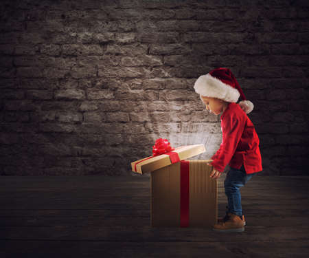 Child that open a magic Christmas giftの写真素材