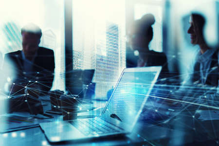 Teamwork works with a laptop. Concept of internet sharing and interconnection. double exposureの写真素材