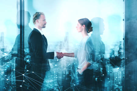 Handshake of two businessperson in office with network effect. concept of partnership and teamworkの写真素材