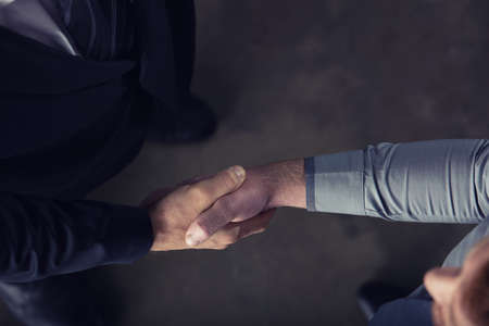 Handshaking business person in office. concept of teamwork and partnershipの写真素材
