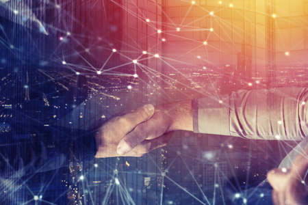 Handshaking business person in office with network effect. concept of teamwork and partnership....