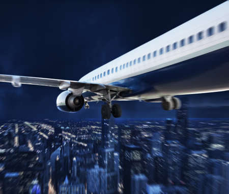 Aircraft travel during night over the cityの写真素材