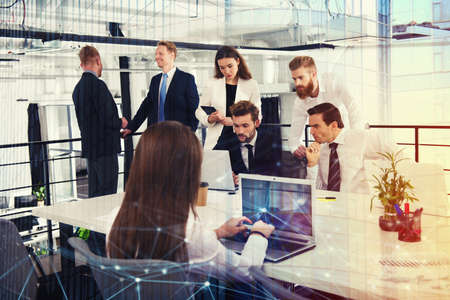 Businessperson in office connected on internet network. concept of partnership and teamworkの写真素材