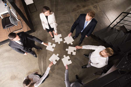 Teamwork of partners. Concept of integration and startup with puzzle pieces