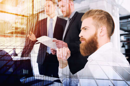 Businessmen that work together in office. Concept of teamwork and partnership. double exposureの写真素材