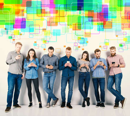 Group of boys and girls connected with their smartphones. Concept of internet and social networkの写真素材