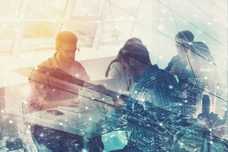 Businessmen that work together in office with network connection effect. Concept of teamwork and partnership. double exposureの写真素材