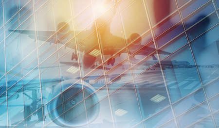 Take off of an aircraft with double exposure of airportの写真素材