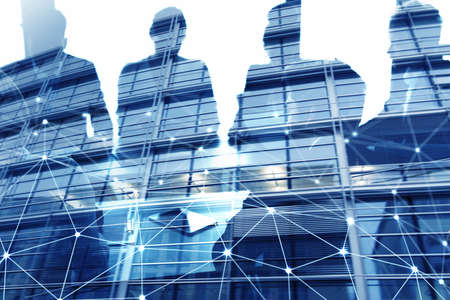 Businessmen that work together in office with network connection effect. Concept of teamwork and partnership. double exposureの写真素材