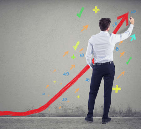 Businessman draws positive statistics of his company. Concept of successの写真素材