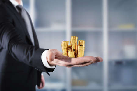 Businessman hold piles of money. Concept of success and company growthの写真素材