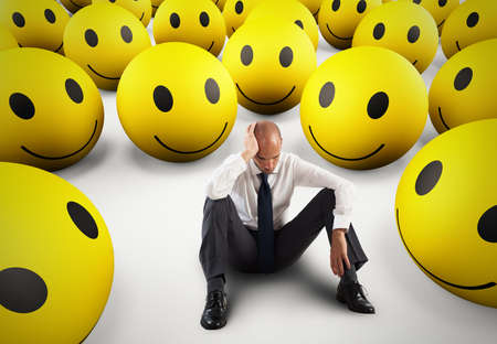 Alone desperate businessman in the middle of happy smileys . 3D Renderingの写真素材