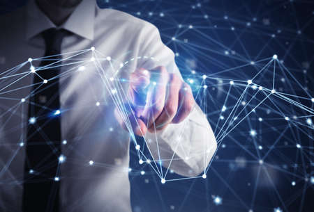 Businessman works with futuristic internet interfaceの写真素材