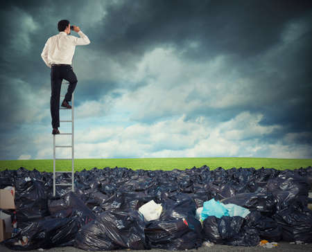 Businessman on a stairs searches far for clean environment. overcome the global pollution problemの写真素材