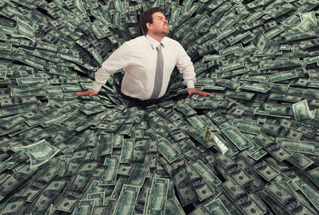 Businessman swallowed by a black hole of money. Concept of failure and economic crisisの写真素材