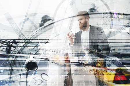 Businessman works with mobile phone in his handの写真素材